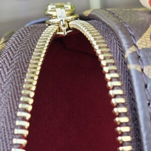 Zip opening of the Monogram Cerises Mini Bumbag with the red lining visible