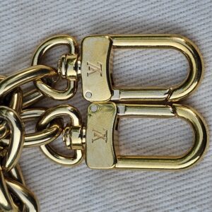 Engraved gold-tone LV clasps on the removable chain strap of the Cerises Mini Bumbag