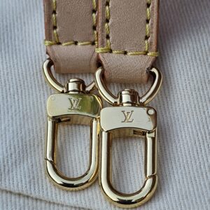 Gold-tone LV snap hooks on the vachetta leather strap of the Cerises Mini Bumbag