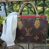 Louis Vuitton Reverse Monogram Giant OnTheGo PM shown with an aftermarket white crossbody strap