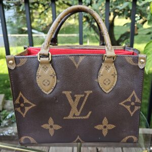 Front view of the Reverse Monogram Giant OnTheGo PM showing the oversized LV logo on the caramel canvas