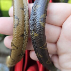Coated canvas handles of the OnTheGo PM held together, showing heavy cracking and finish loss