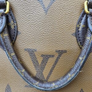 Close-up of heavy cracking and peeling along the coated canvas handles of the OnTheGo PM