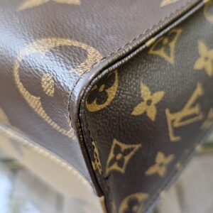 Close-up of edge wear and scuffing along a seam of the Giant Reverse Monogram OnTheGo PM