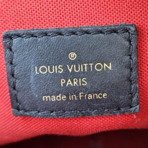 LOUIS VUITTON PARIS made in France tag stitched into the red interior of the OnTheGo PM