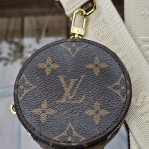 Front of the Monogram round pouch with its gold-tone snap hook