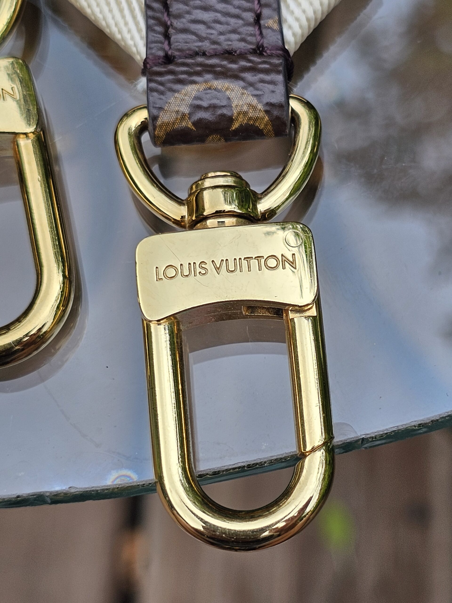 LOUIS VUITTON engraved gold-tone snap hook on the jacquard strap
