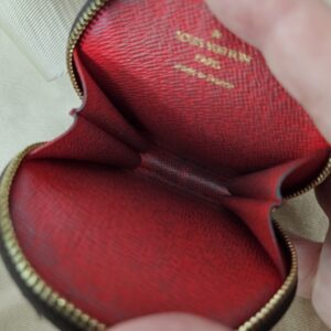 Red interior of the Monogram round pouch held open