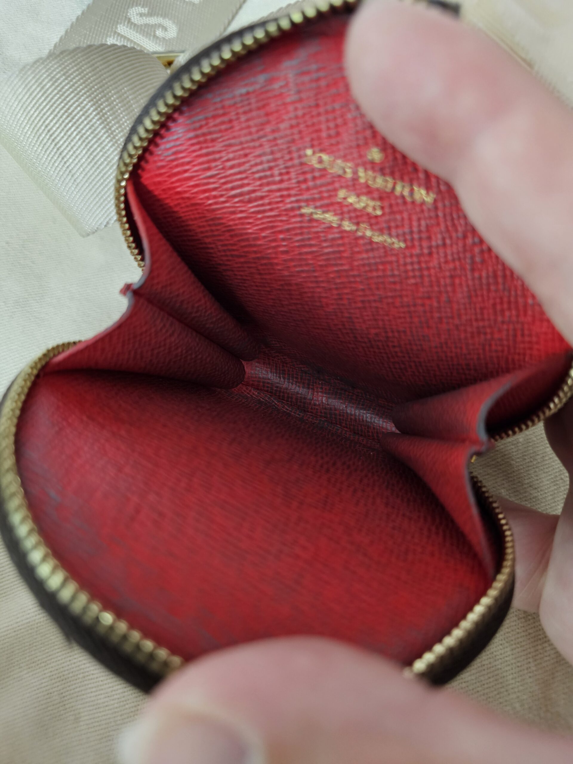 Red interior of the Monogram round pouch held open