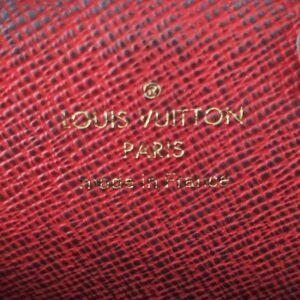 LOUIS VUITTON PARIS made in France stamp inside the red lining of the round pouch