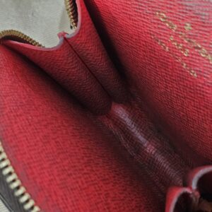 Red interior of the round pouch showing coin residue