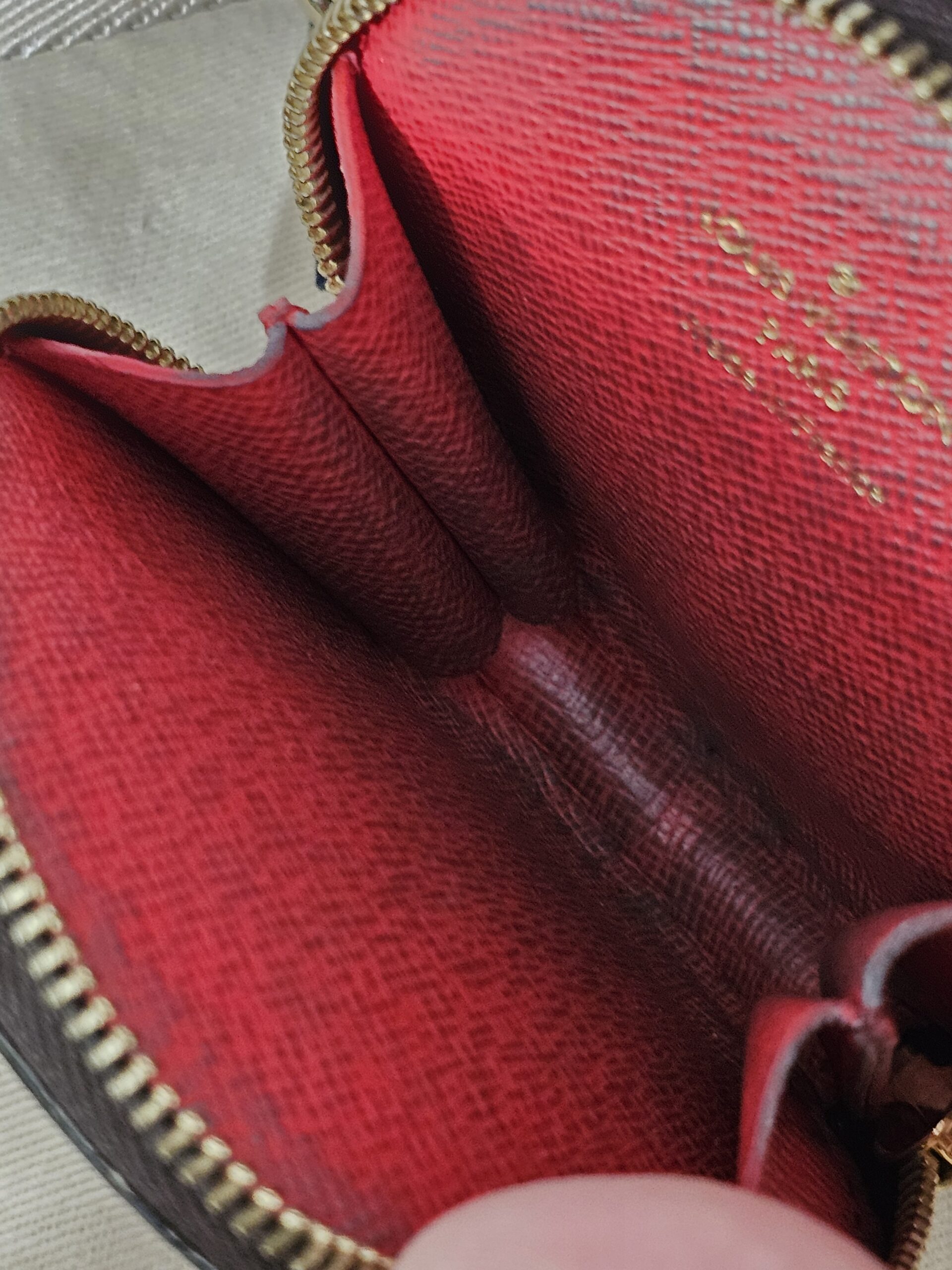 Red interior of the round pouch showing coin residue