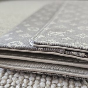Edge view of the gray Mini Lin Sarah Wallet showing light corner and edge wear