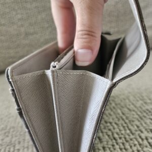 Zipped coin compartment of the gray Monogram Mini Lin Sarah Wallet held open