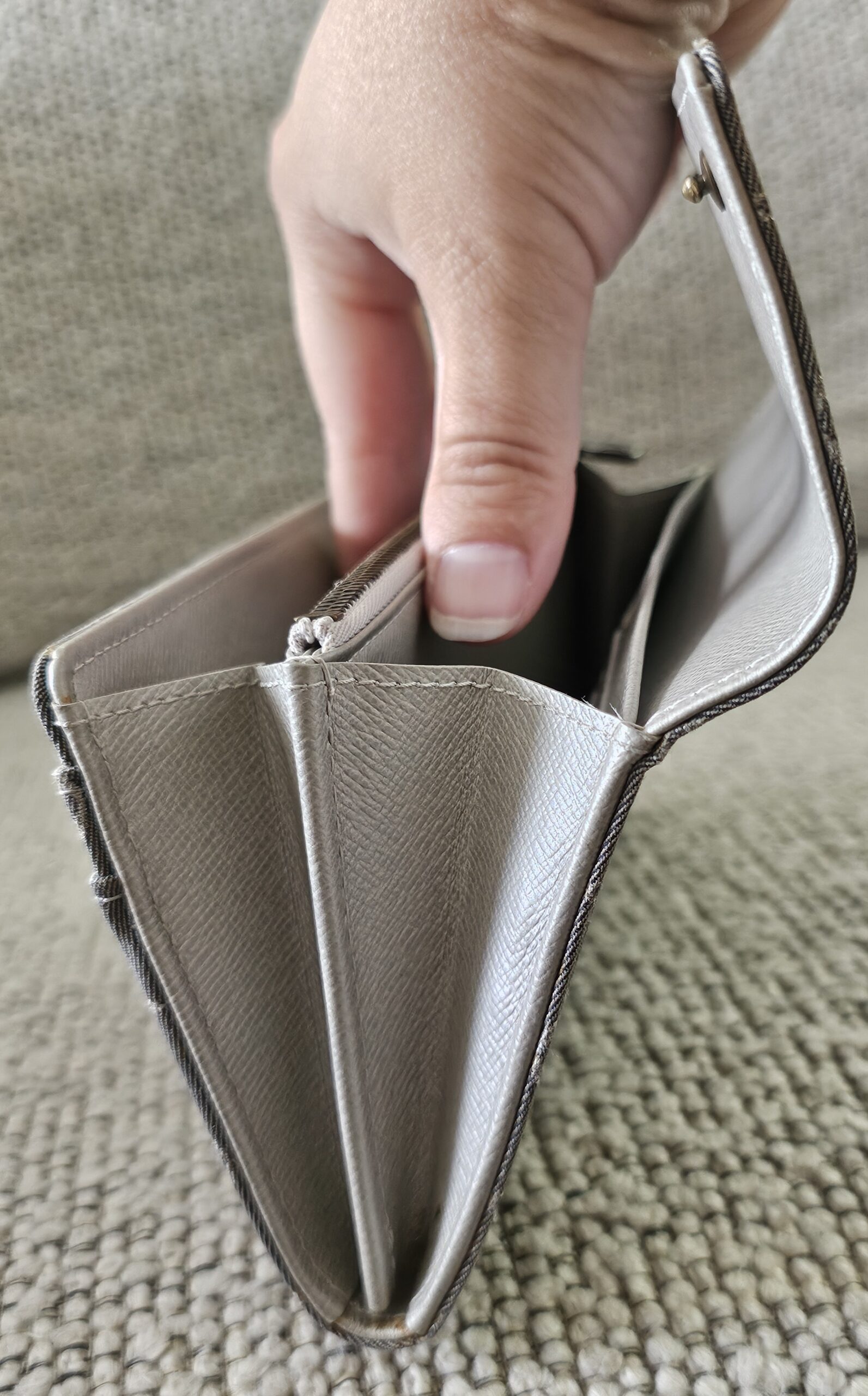 Zipped coin compartment of the gray Monogram Mini Lin Sarah Wallet held open