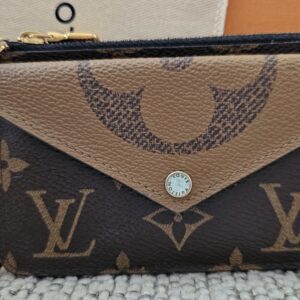 Louis Vuitton Reverse Monogram Recto Verso Card Holder - front view with the envelope snap pocket and gold-tone hook