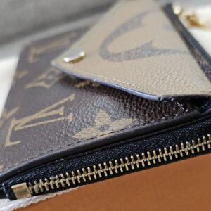 Zippered compartment and gold-tone zip on the Reverse Monogram Recto Verso card holder
