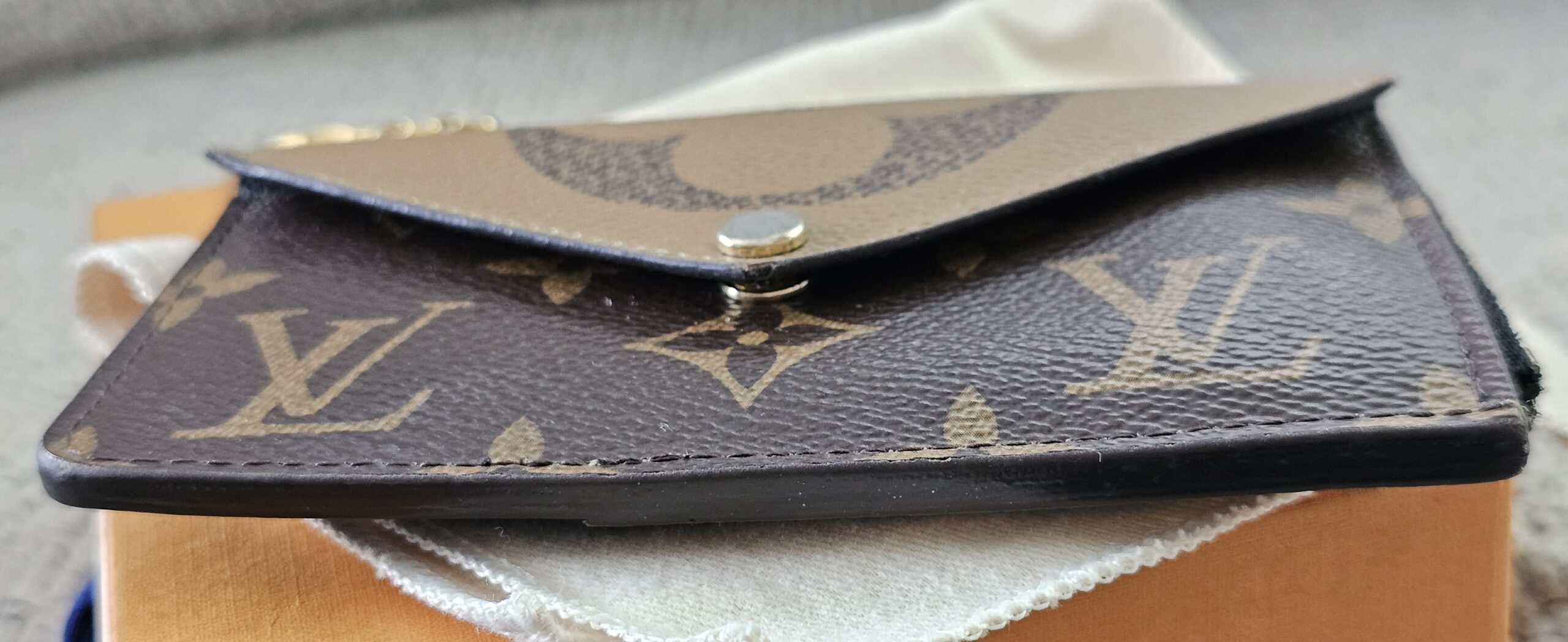 Envelope-style snap pocket on the front of the Monogram Reverse Recto Verso card holder
