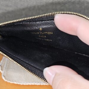 Recto Verso card holder opened to show the black leather interior and Louis Vuitton Paris stamp