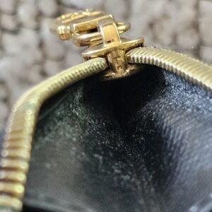 Close-up of the gold-tone zipper pull on the Reverse Monogram Recto Verso card holder