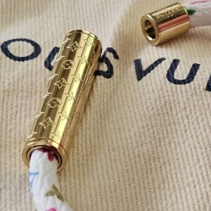 White Monogram Multicolor Confidential Bracelet with the gold-tone clasp released, showing the engraving