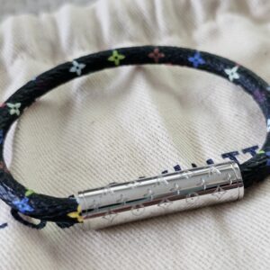 Angled view of the black Monogram Multicolor Confidential Bracelet and its silver-tone clasp
