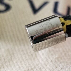 Close-up of the silver-tone barrel clasp on the black Monogram Multicolor Confidential Bracelet