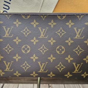 Front view of the Louis Vuitton Monogram Key Pouch M with gold-tone zip