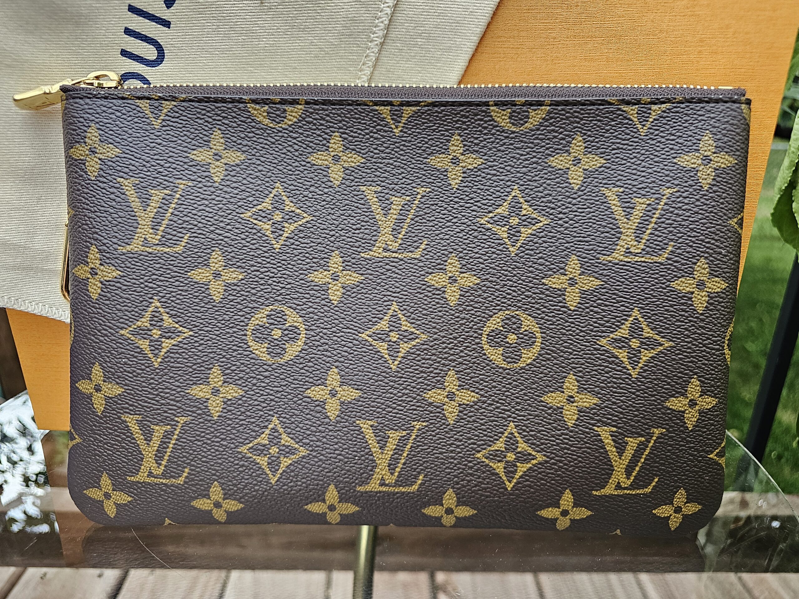 Front view of the Louis Vuitton Monogram Key Pouch M with gold-tone zip