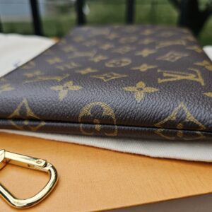 Attached gold-tone chain and key hook on the Louis Vuitton Monogram Key Pouch M