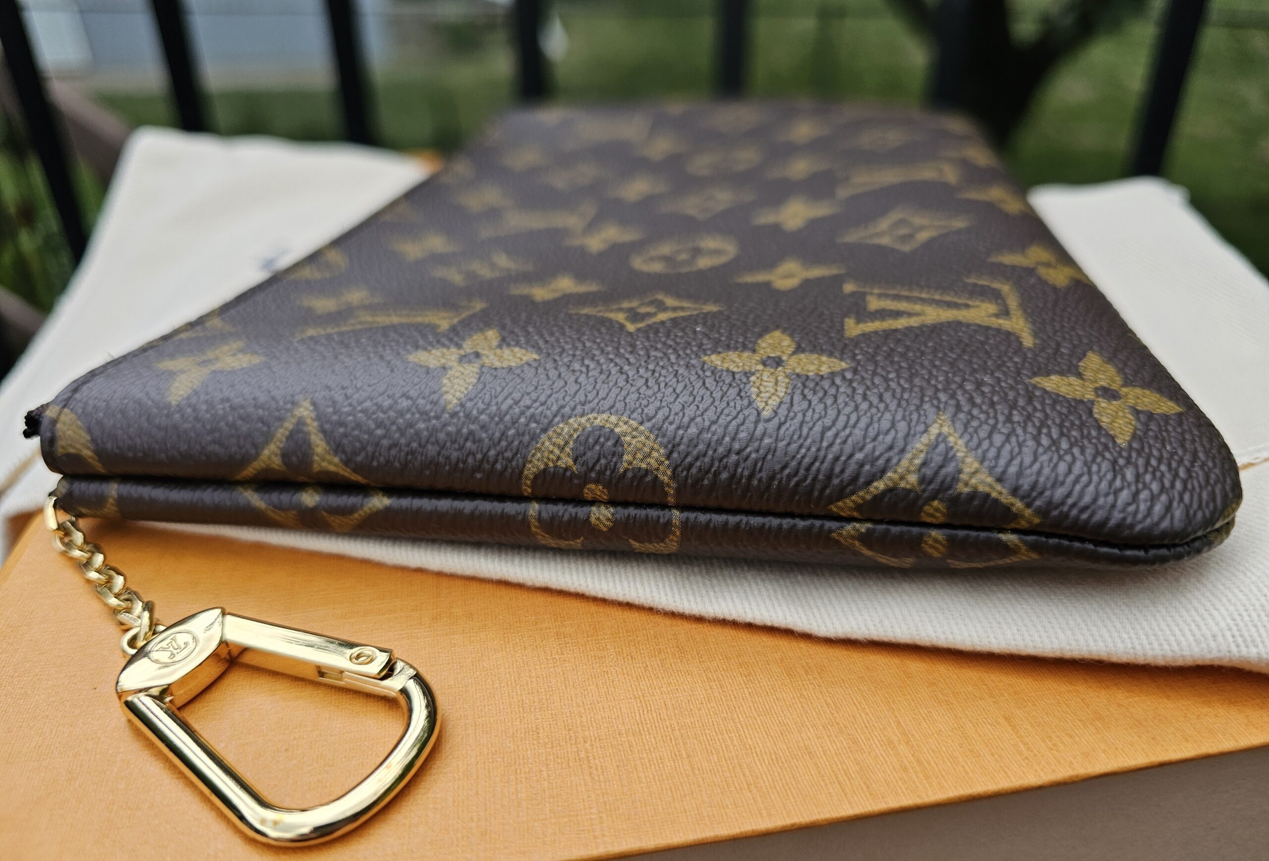 Attached gold-tone chain and key hook on the Louis Vuitton Monogram Key Pouch M