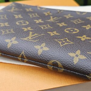 Louis Vuitton Monogram Key Pouch M laid flat showing its slim profile