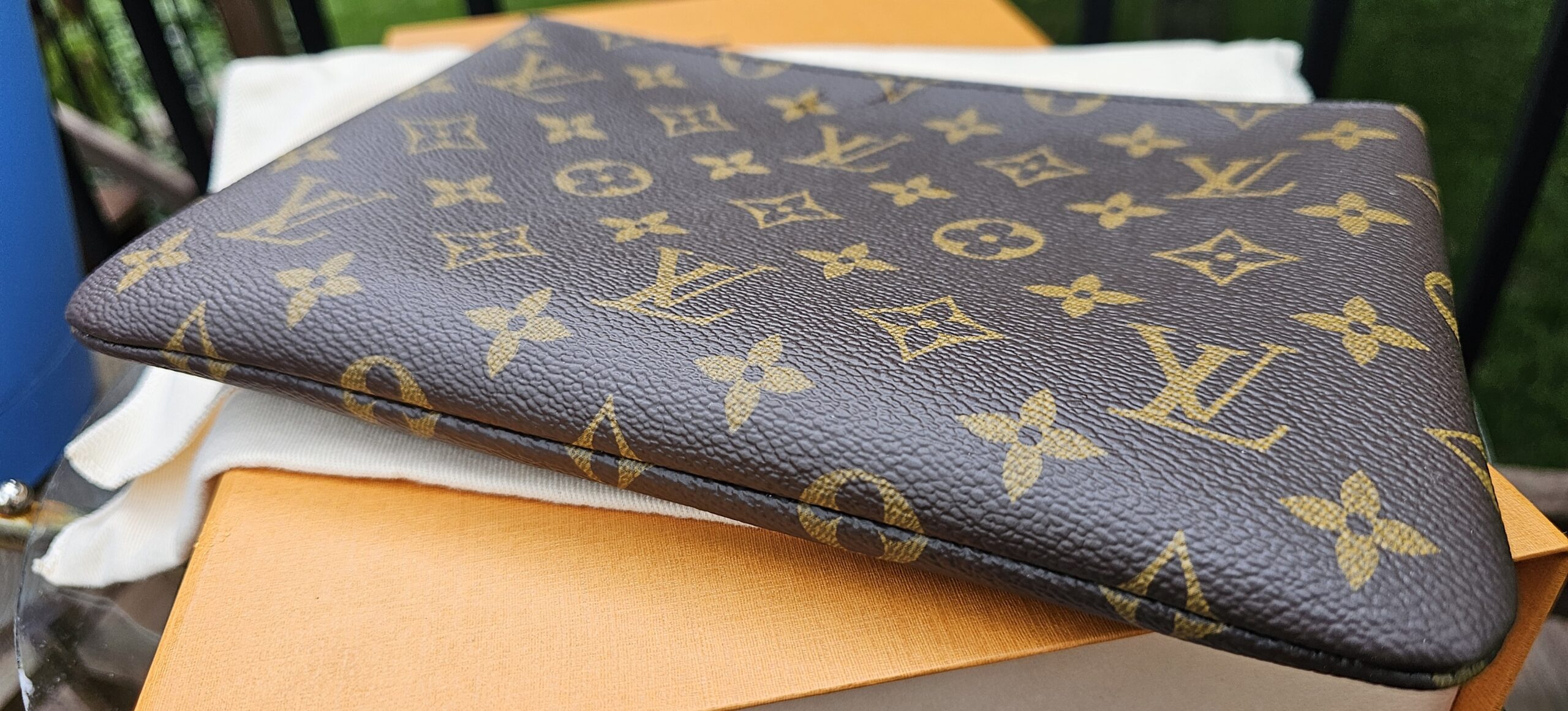 Louis Vuitton Monogram Key Pouch M laid flat showing its slim profile