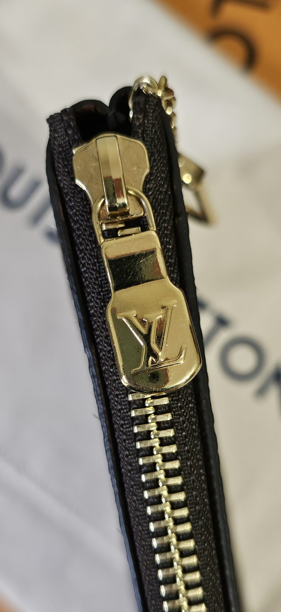 Gold-tone LV zip pull on the Monogram Key Pouch M