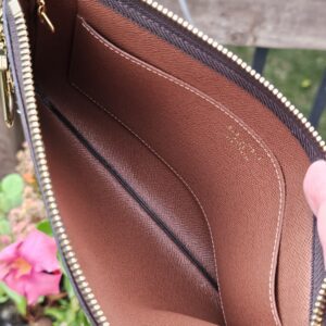 Key Pouch M opened to show the brown cross-grain leather interior and slip pocket