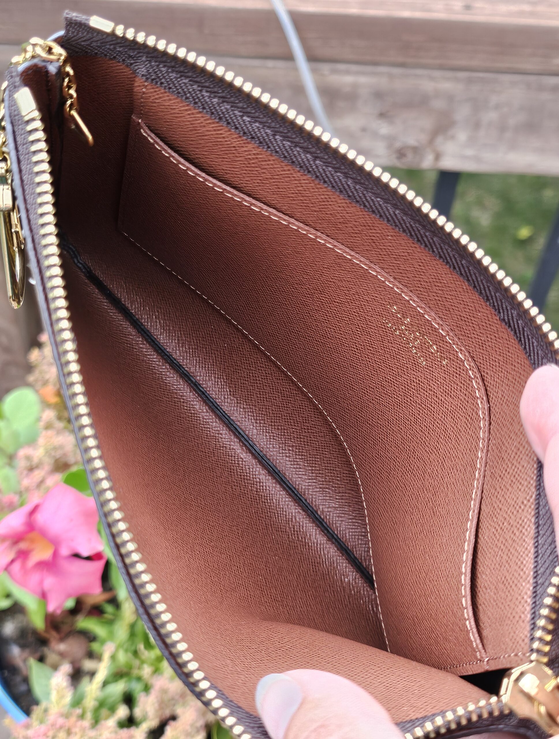 Key Pouch M opened to show the brown cross-grain leather interior and slip pocket