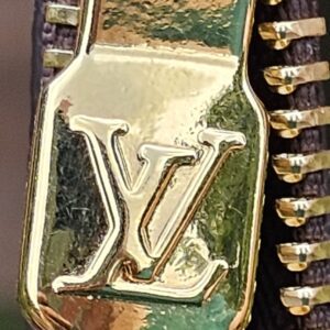 Close-up of the gold-tone zipper and LV pull on the Monogram Key Pouch M