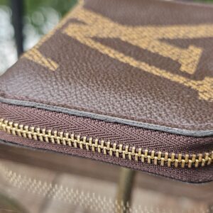 Side of the Monogram Giant Zippy Coin Purse showing light edge wear