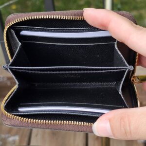 Monogram Giant Zippy Coin Purse opened to show the black leather interior and card slots