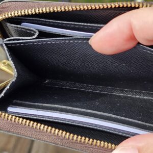 Interior pockets and card slots of the Monogram Giant Zippy Coin Purse held open