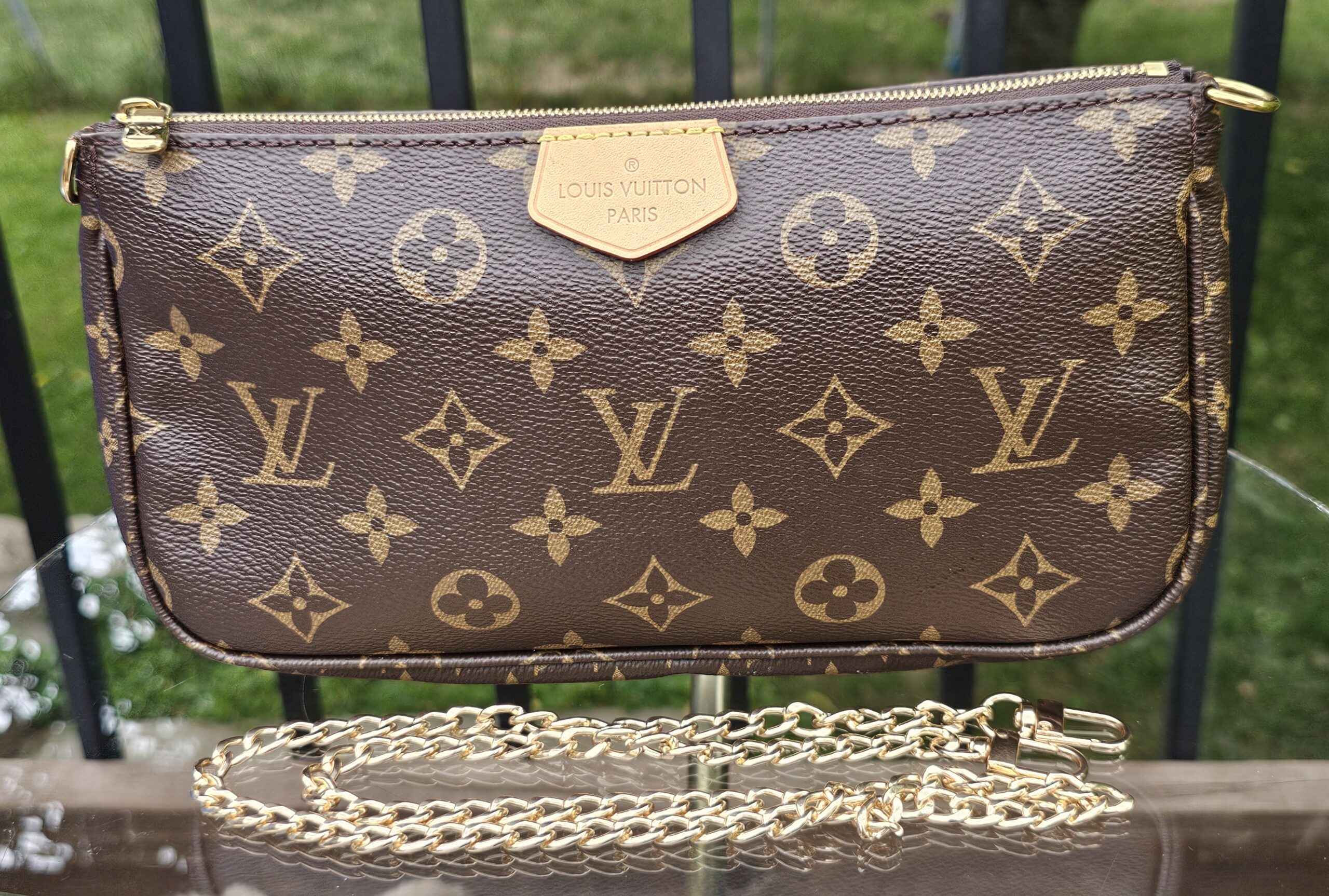 Louis Vuitton Monogram Multi Pochette Accessoires large pochette shown with the included gold-tone chain