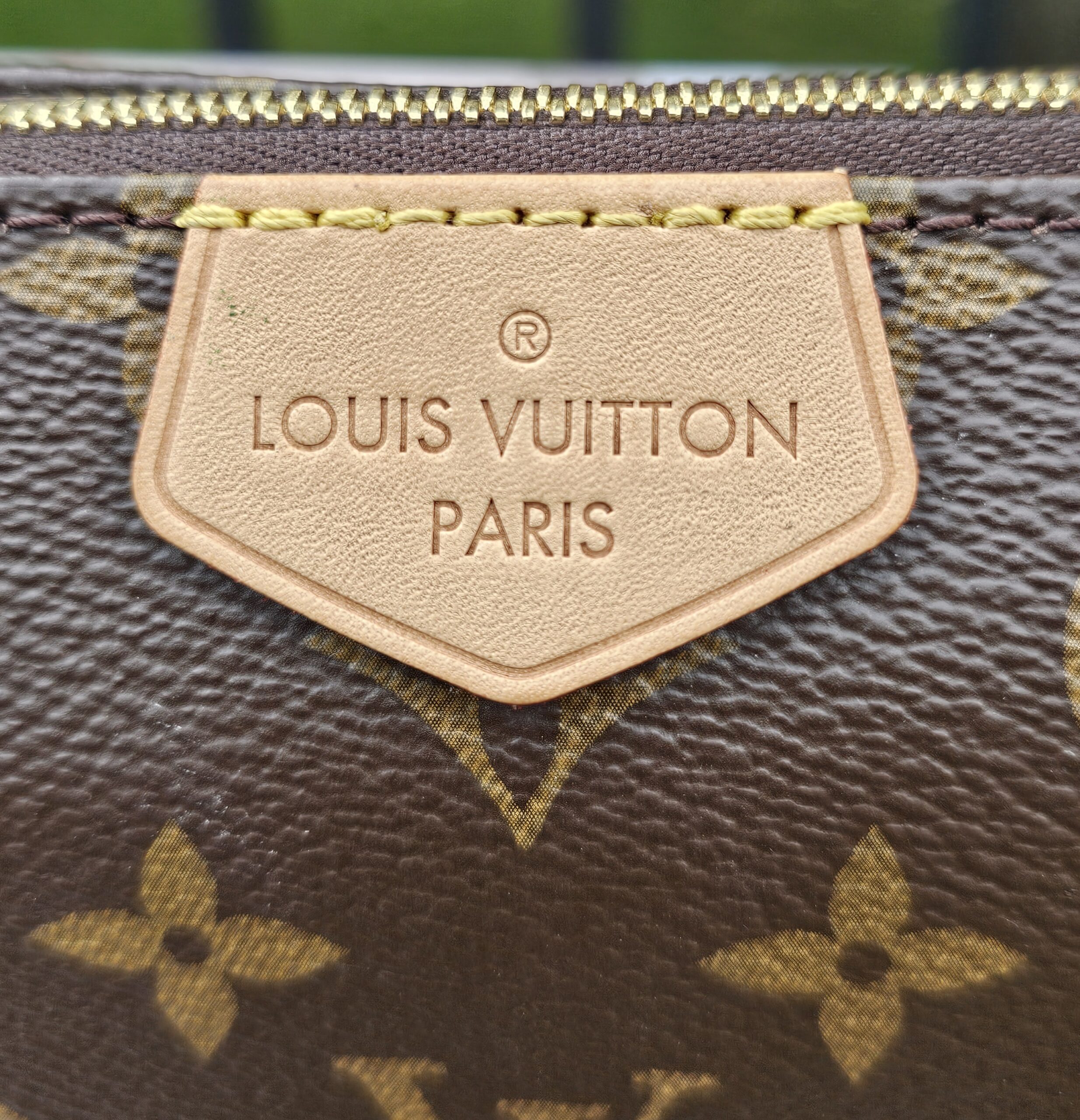 LOUIS VUITTON PARIS embossed vachetta name tag on the Monogram large pochette