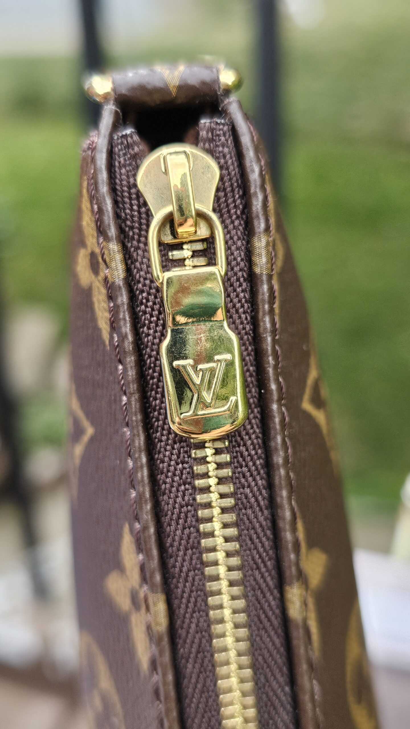 Gold-tone LV zip pull on the Monogram Multi Pochette Accessoires large pochette