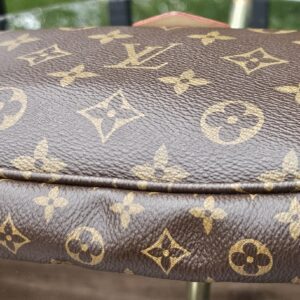 Top edge of the Monogram large pochette showing the zip and canvas condition