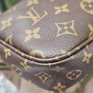 Close-up of the Monogram coated canvas on the large pochette