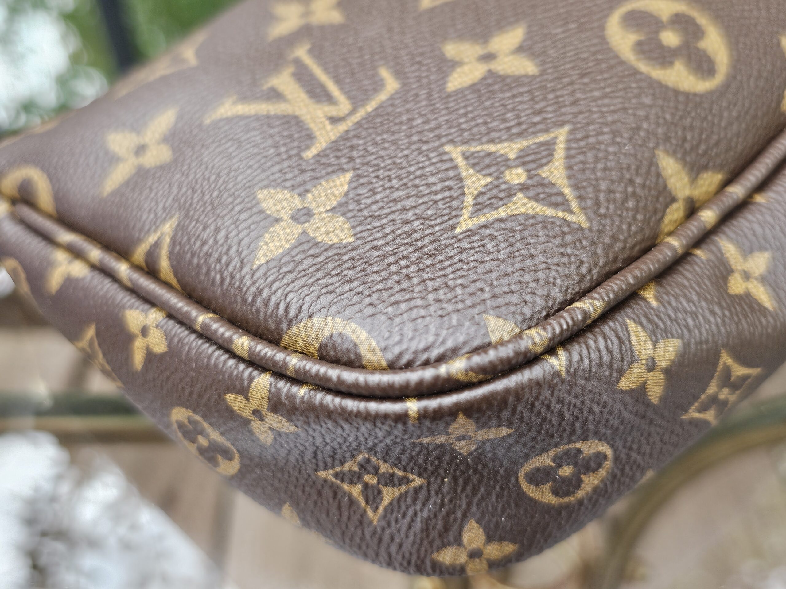 Close-up of the Monogram coated canvas on the large pochette
