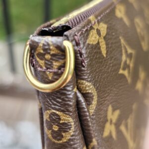 Gold-tone D-ring attachment on the Monogram Multi Pochette Accessoires large pochette