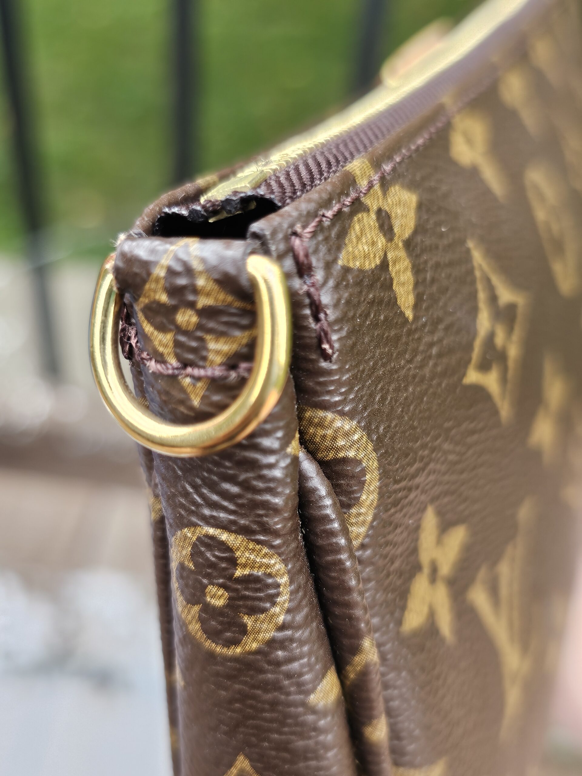 Gold-tone D-ring attachment on the Monogram Multi Pochette Accessoires large pochette