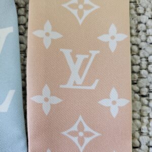 Close-up of the Monogram print on the peach end of the LV Aurora bandeau