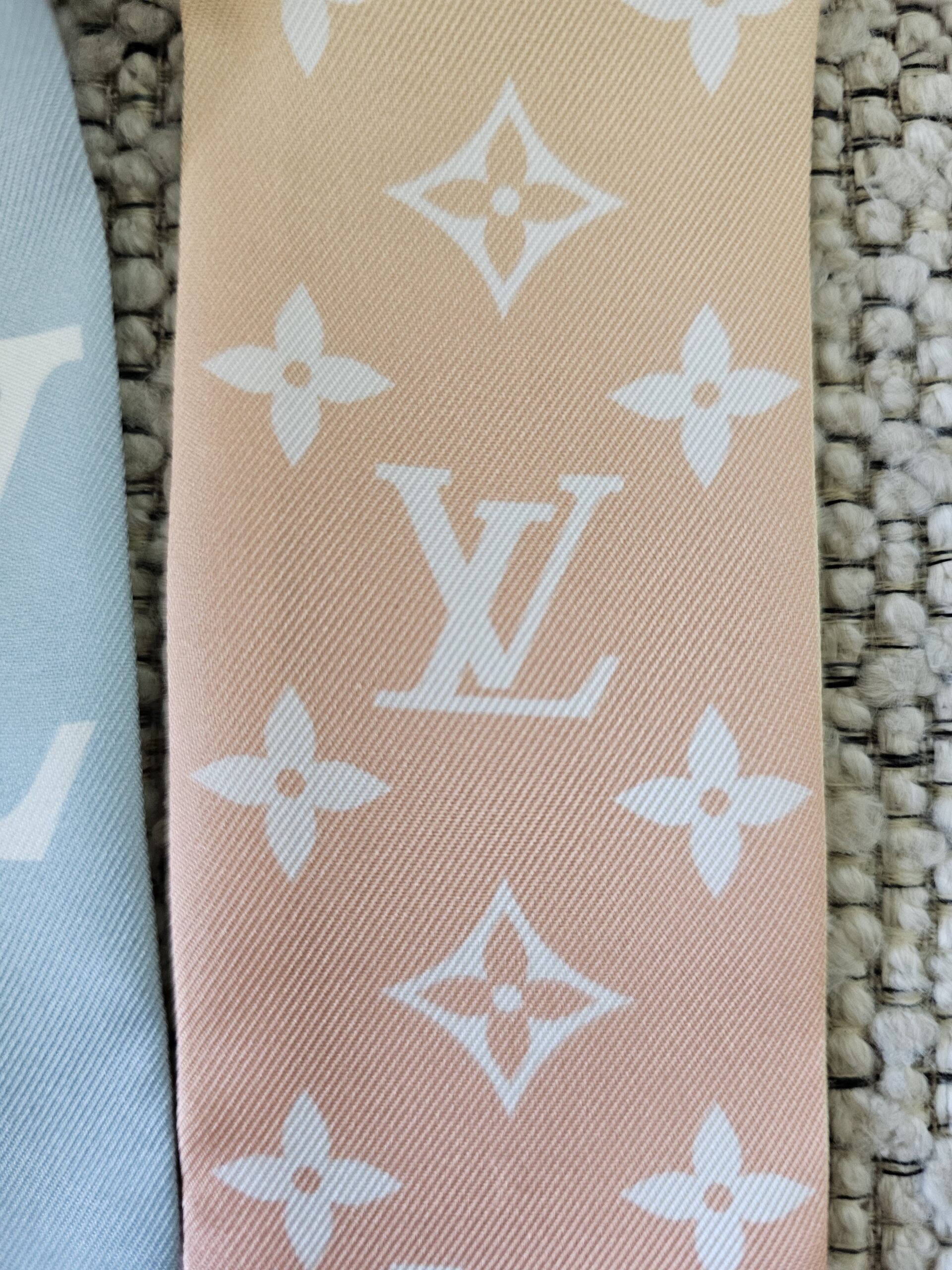 Close-up of the Monogram print on the peach end of the LV Aurora bandeau